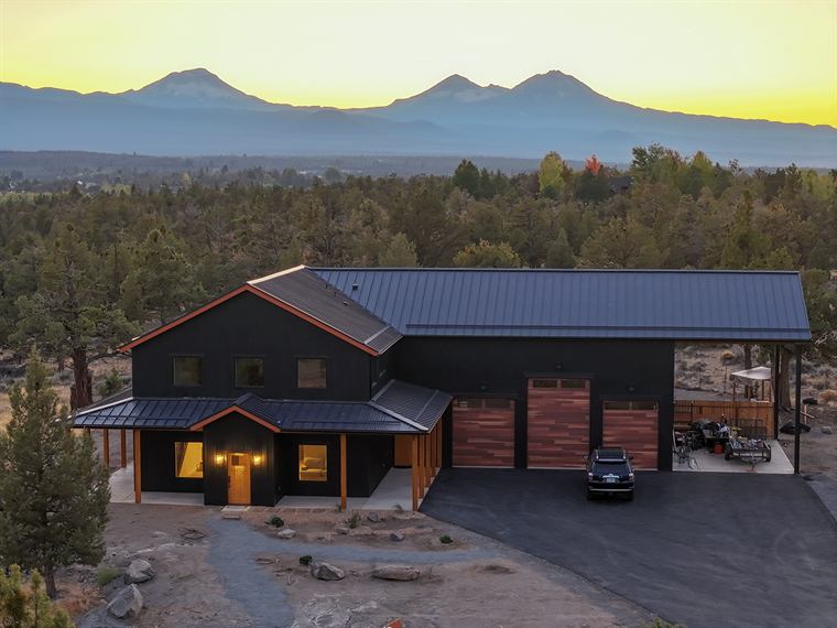 Aerial view of the barndo at sunset with the Cascade mountains behind it
