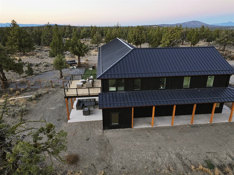 Aerial view of the barndo and its upper deck among juniper trees