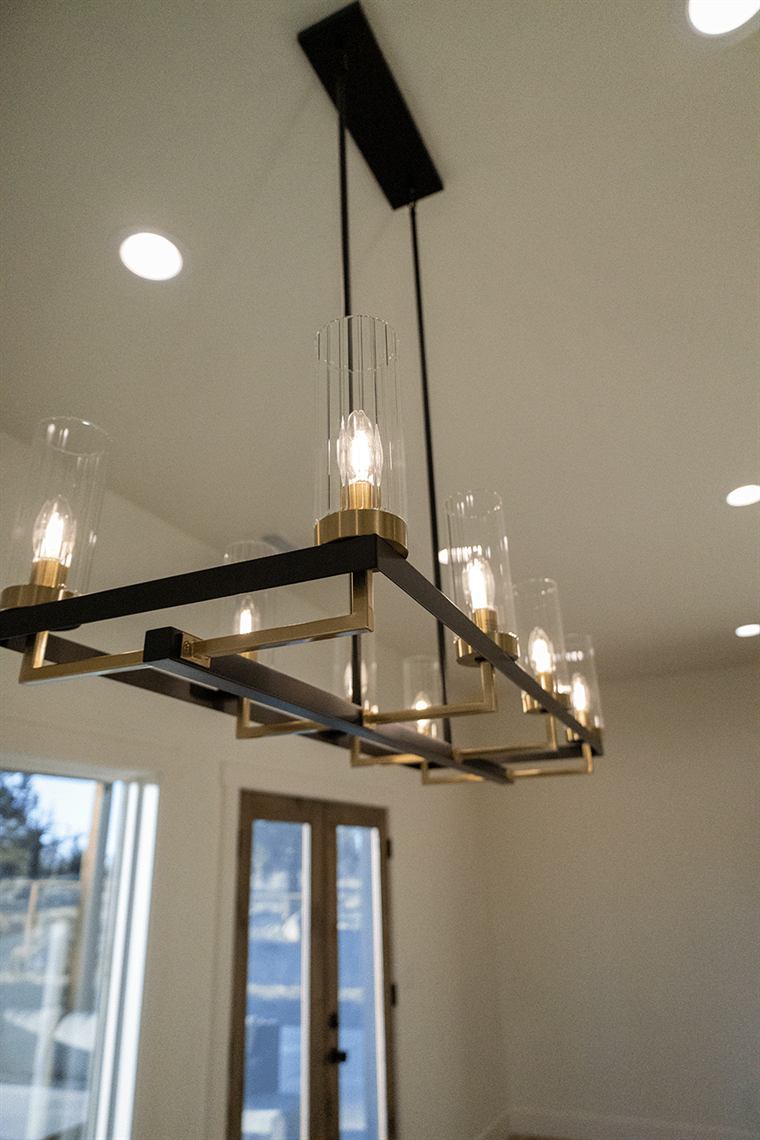 Black rectangular chandelier hanging from a high ceiling