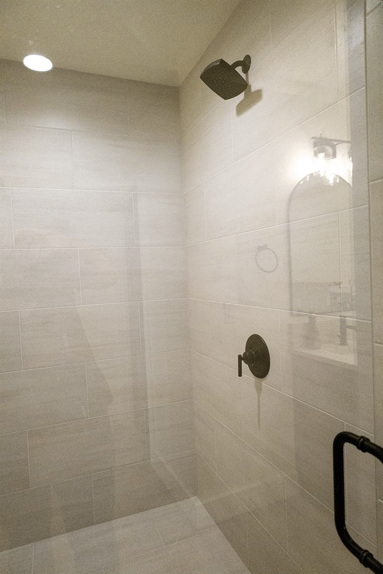 Large-format tile shower with black fixtures