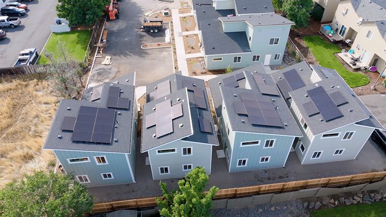 Wide aerial view of the Habitat for Humanity homes with solar panels