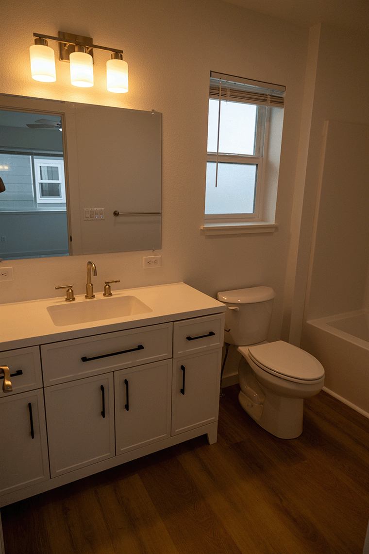 Bathroom with a white vanity and a window