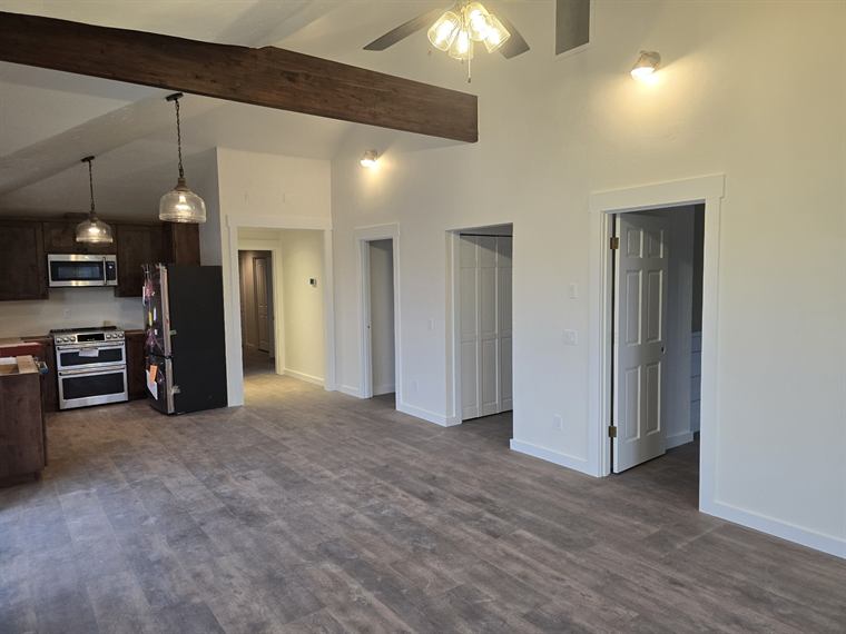 Kitchen remodel with an exposed wood beam and pendant lights