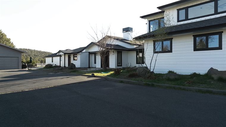 Street view of the remodeled ranch house and neighboring homes