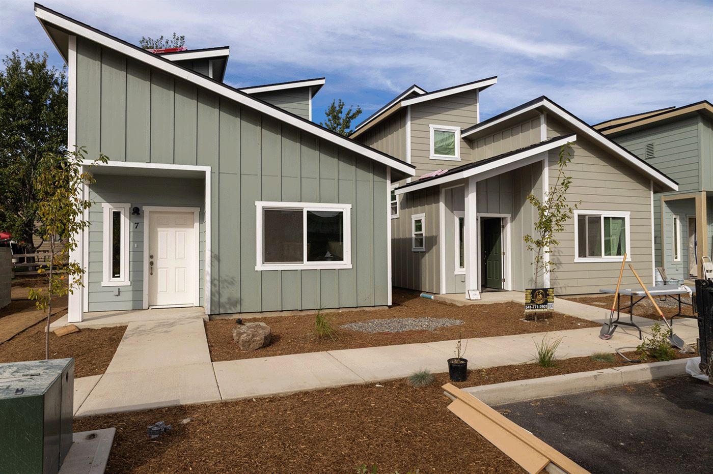 Row of new sage-green Habitat for Humanity homes